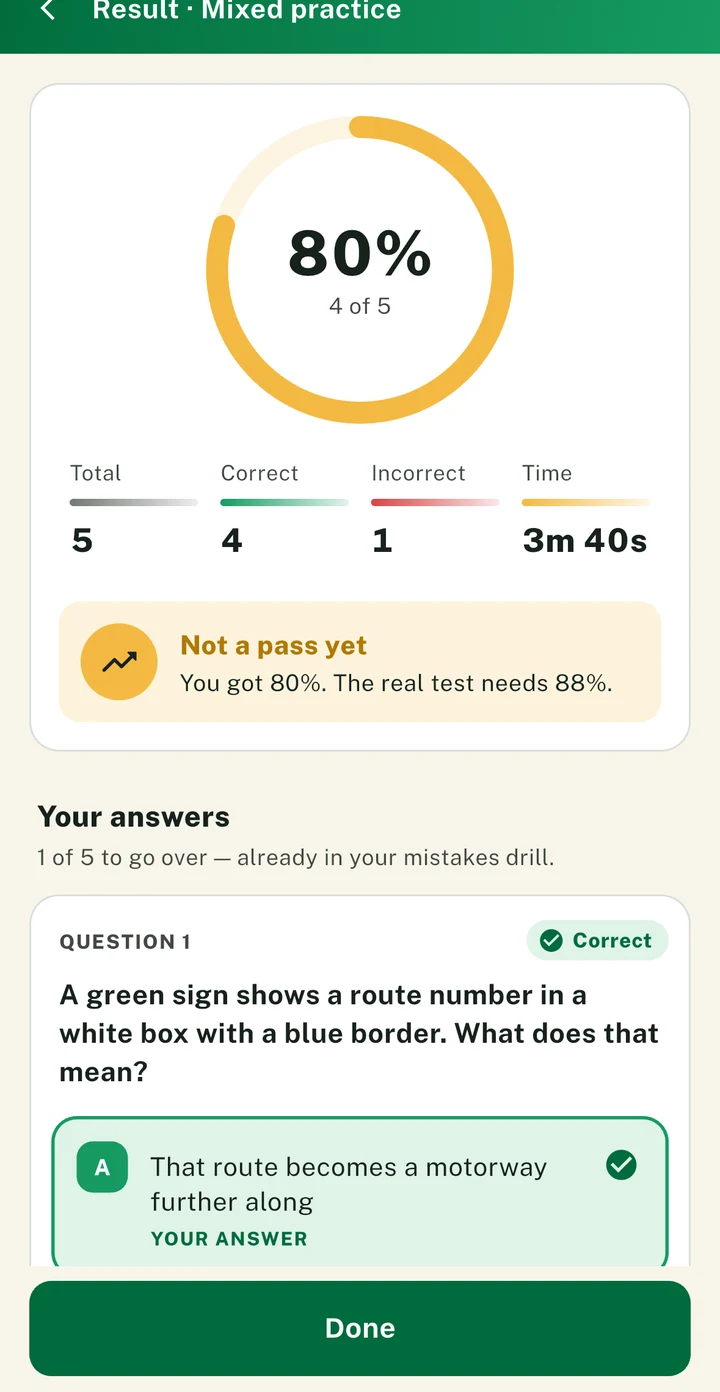 The PassDrive result screen: a score ring, the totals, and the questions to go over with the wrong ones marked